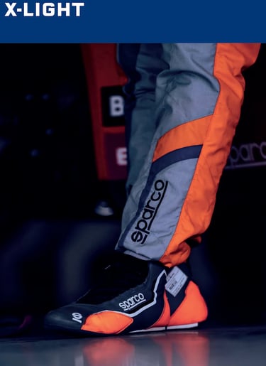 Professional Sparco racing suit and high-performance motorsports shoes in grey and orange.