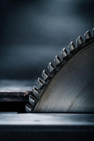 Close-up of a circular saw blade with detailed teeth and metal texture