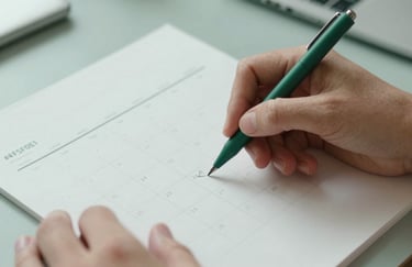 Close-up of hands sketching a social media content calendar on parchment paper with a matte green pen. Minimalist, professional creative workspace, soft lighting, #F5F0E1 and #2E4D3E.