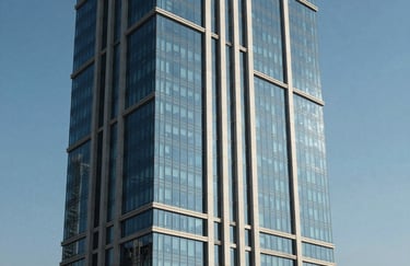 A minimalist photography of a modern high-rise building with glass facade reflecting a clear blue sky in a Middle Eastern / Gulf metropolis, emphasizing efficiency and modern architecture.