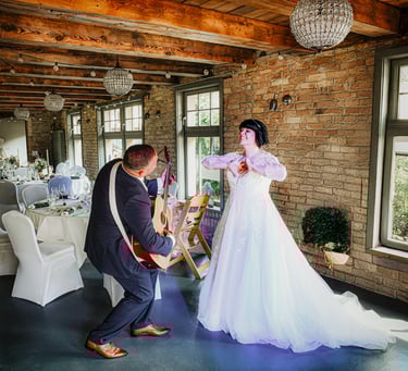 Brautpaar tanzt bei Hochzeitsfeier in rustikaler Location mit Backsteinwand und Holzbalkendecke.
