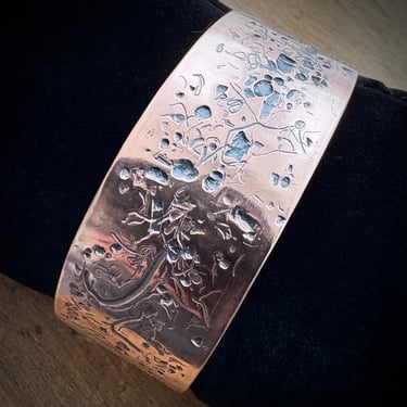 A heavy copper cuff bracelet textured with metal scraps
