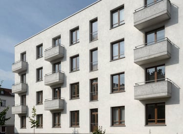 Exterior of a renovated, modern apartment building in a clean Zentraleuropäisch / Deutsch neighborhood.