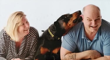  Cheeky Loki our Doberman in a batman collar gives mark a big ear lick while Claire laughs-just another day at collar Rack HQ