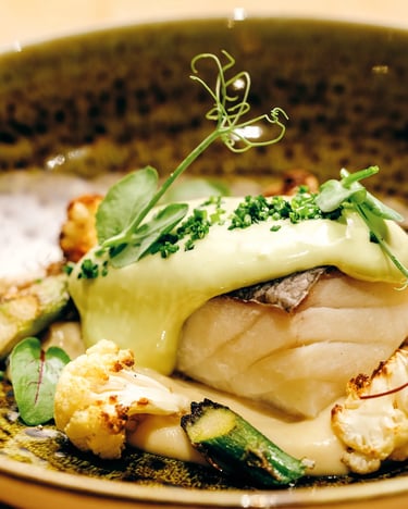 Bacalao confitado con coliflor en diferentes texturas y espárragos verdes en Es Mestral. Ses Salines.