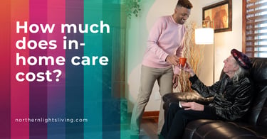 A male caregiver serving tea to a senior man in a living room, discussing in-home care costs.
