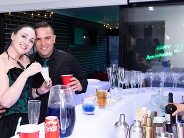 Carly and Kahn with the Happy 20th Anniversary neon in the background, Redlands.