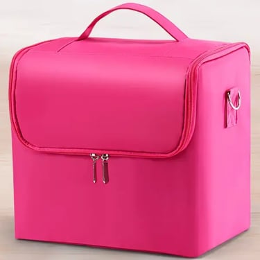 Hot pink professional makeup train case with a zipper closure and top handle for travel storage.
