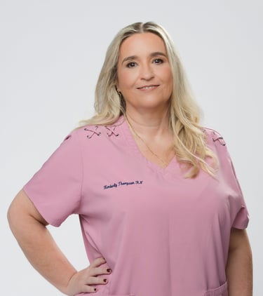 Kimberly Thompson RN, a blonde female healthcare professional wearing pink medical scrubs.