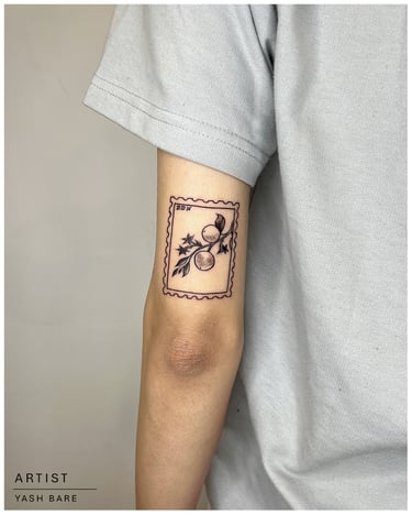 Photo of a cherry stamp tattoo on the arm