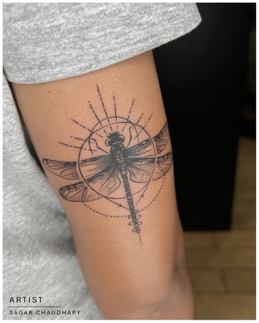 Photo of a drangonfly tattoo on the arm