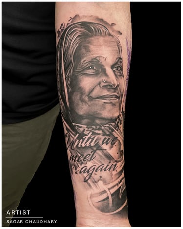 Photo of a portrait tattoo of a women on the arm