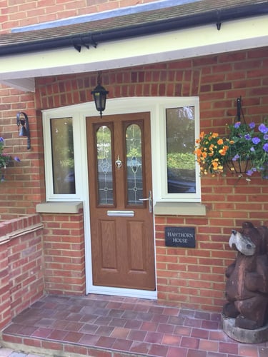 oak wood colour composite door with decorative glass and half glazed side panels