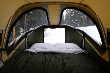 Cozy bedding inside a Thule M Approach Rooftop Tent