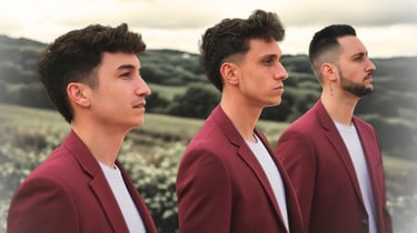 Three men in matching maroon blazers standing in a row against a scenic countryside background.