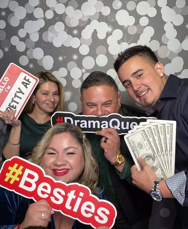Group of friends posing with prop signs at a photo booth rental event in Long Island NY