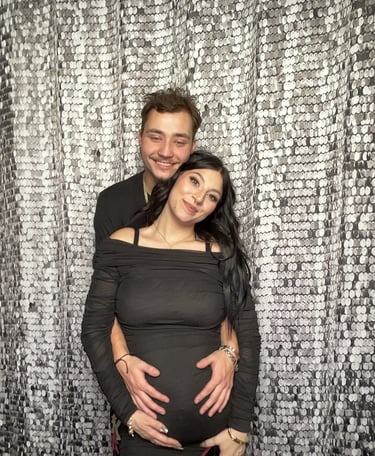 Couple posing in front of sequin backdrop at a photo booth rental event in Suffolk County NY