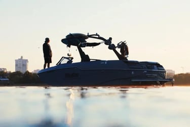 Malibu M240 wake and surf performance boat on Ontario lake at sunrise - STO Boats