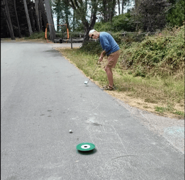 Outdoor golf game using street ball at forest campground
