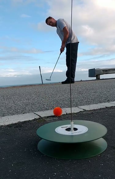 Putting a street golf ball onto a urban golf capture hole