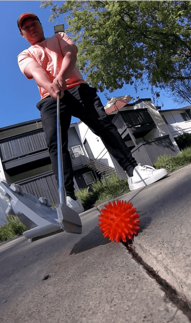 Player making putting shot with street golf ball, club with cover and putting adapter