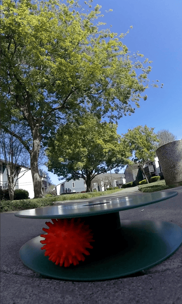 Urban golf capture hole with street golf ball resting inside