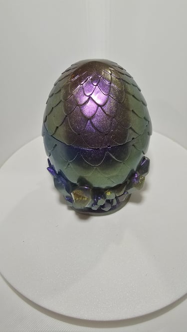 Iridescent purple and green resin dragon egg container with a scaly texture and crystal base.