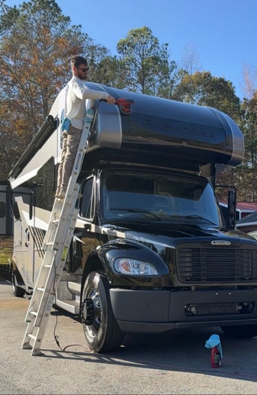Man polishing frieghtliner RV