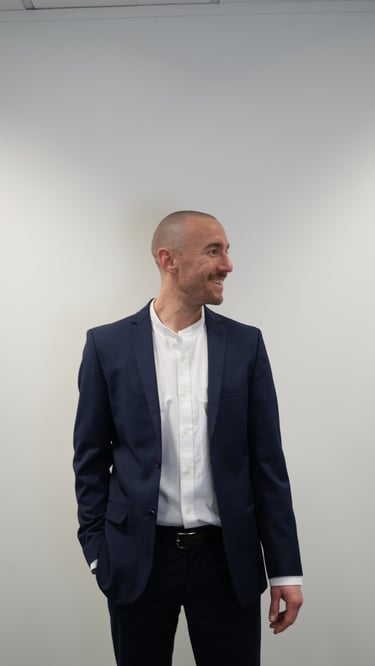 man in blue suit smiling