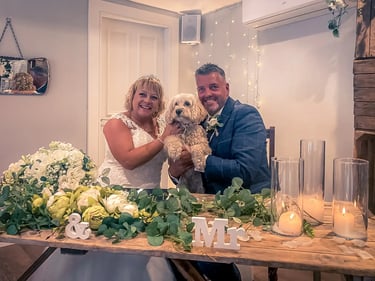 Couple With Their Dog At The end Of Their Ceremony