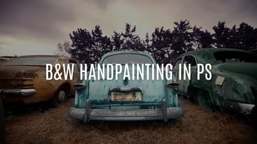 A black and white image of vintage cars with selective hand-painted color in Photoshop, showcasing artistic editing technique
