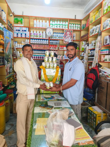 Two men standing in a local agriculture supply store with shelves of fertilizers and pesticides.