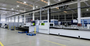 Modern industrial manufacturing facility with automated production lines and metal fabrication machinery.