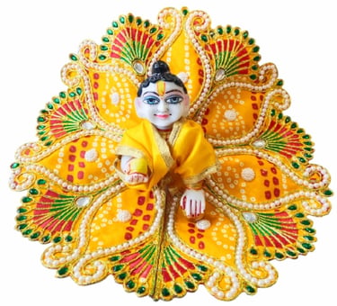 Laddu Gopal marble statue dressed in a yellow bandhani poshak with peacock feather patterns.