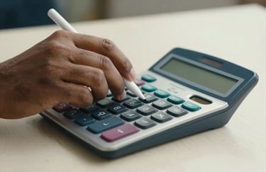 Close-up of a South Asian professional's hands using a calculator and a digital stylus, representing accuracy and modern bookkeeping practices. Palette of off-white and dark blue.