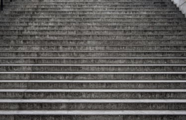 Ascending concrete steps illustrating rigorous organisational structure and project stability.