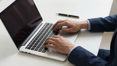 A close-up of a professional handshake in a bright office, symbolizing a successful ISO 27001 audit. Accents of deep navy blue in the clothing.