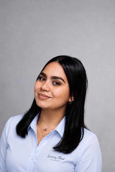 Professional portrait of a woman in a light blue shirt representing Luxury Shine Cleaning services.