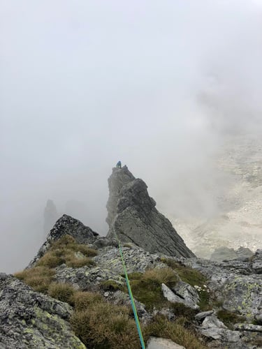 Climbing on Spigolo Gervasutti with classic Masino afternoon clouds