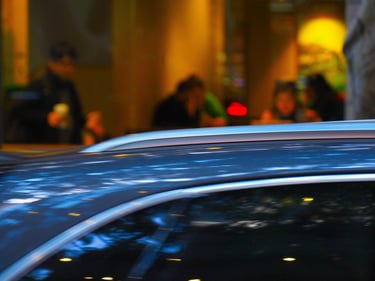 Cafe seen beyond top of car.