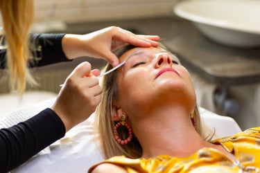 Esthéticienne professionnelle effectuant un soin d'épilation et de modelage des sourcils