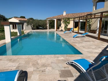 Swimming pool with wide view and waterfall cascade built-in at Domaine Des Lucques