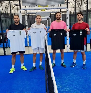 Four male padel players holding custom TOP branded jerseys on a blue indoor padel court.