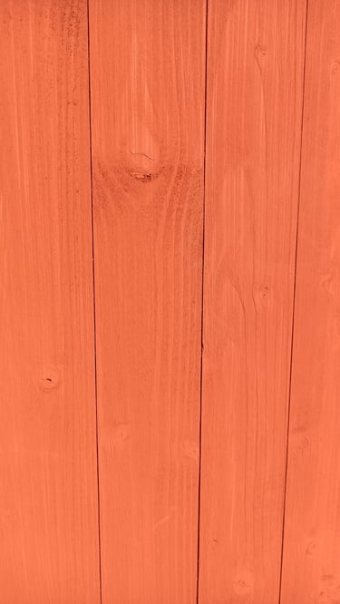 Tust red newly painted on wood barn paint
