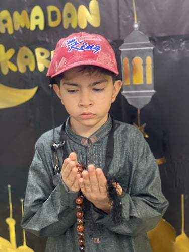 "Close-up of a delicious dessert with layers of cake, cream, and fruit, served on a white plate."