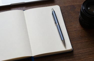 A top-down view of an organized desk with a notebook and a sleek digital pen, Soft Cloud White and Muted Steel Blue aesthetic, Central European / German interior.