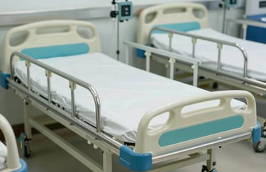 A detailed shot of the manufacturing process of a stainless steel hospital bed, with light lime green and sage green accents in the shop.
