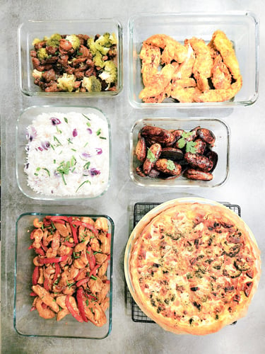 Healthy meal prep containers with chicken stir fry, white rice, broccoli, and a savory quiche.