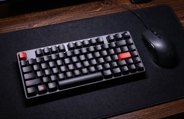 A top-down view of a sleek mechanical keyboard on a dark navy desk mat next to a precise optical mouse, moody cinematic lighting.