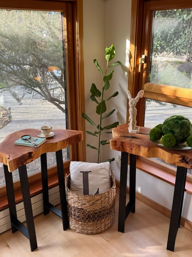 two live edge coffee tables with decorative pieces on the top as a stageing